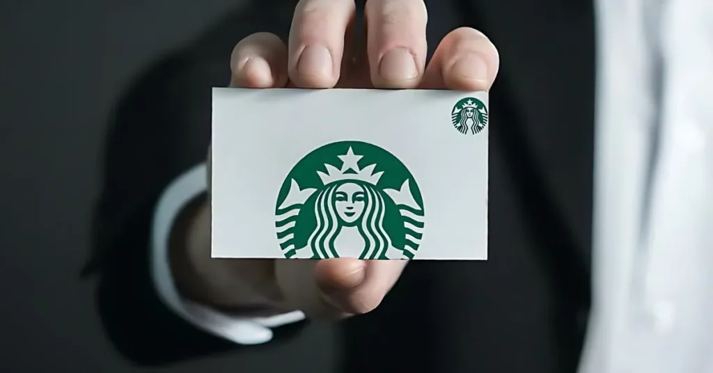 A man showing his Starbucks Gift Card - How to Check the Balance